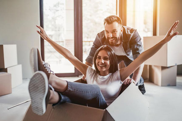 Home buyers moving in sitting in box